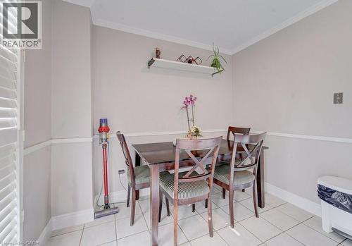 Dining area featuring ceramic tile flooring, crown molding, chair rail molding, and a built-in wall shelf - 334 Christopher Drive, Cambridge, ON - Indoor Photo Showing Dining Room