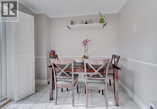 Dining area featuring neutral wall tones, white crown molding, chair rail molding, and a white floating shelf - 334 Christopher Drive, Cambridge, ON - Indoor Photo Showing Dining Room