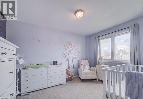 Carpeted room featuring a double window with light-filtering curtains, a flush-mount ceiling light fixture, and walls finished in a light hue - 334 Christopher Drive, Cambridge, ON - Indoor Photo Showing Bedroom