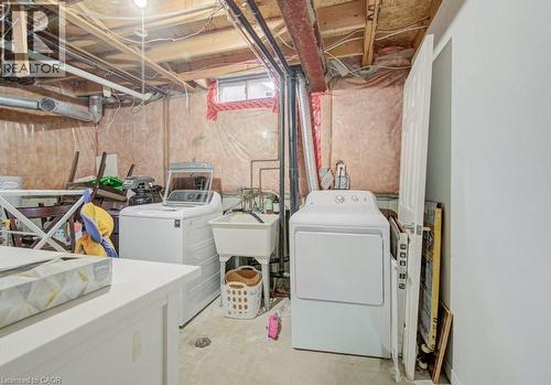 Basement utility area featuring exposed joist ceiling, insulation-backed walls, concrete flooring, and a utility sink - 334 Christopher Drive, Cambridge, ON - Indoor Photo Showing Laundry Room