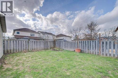 Expansive backyard featuring a lush lawn and perimeter wood fencing - 334 Christopher Drive, Cambridge, ON - Outdoor