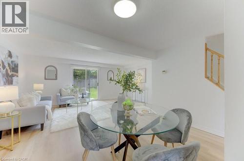 Open-concept living space featuring light wood-finish flooring, white walls, and a recessed ceiling light - 603 Pinerow Crescent Unit# B, Waterloo, ON 