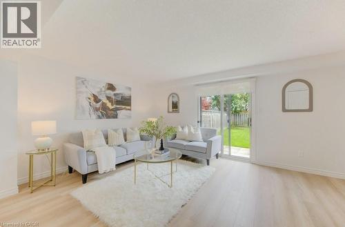 Light wood-finish flooring complements the neutral wall tones - 603 Pinerow Crescent Unit# B, Waterloo, ON 