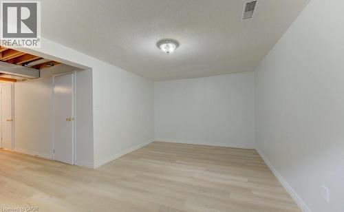 Room featuring light wood-finish flooring, white painted walls, and white baseboards - 603 Pinerow Crescent Unit# B, Waterloo, ON 