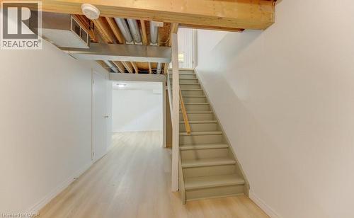 Light wood-finish flooring extending into a bright, neutral-toned hallway - 603 Pinerow Crescent Unit# B, Waterloo, ON 