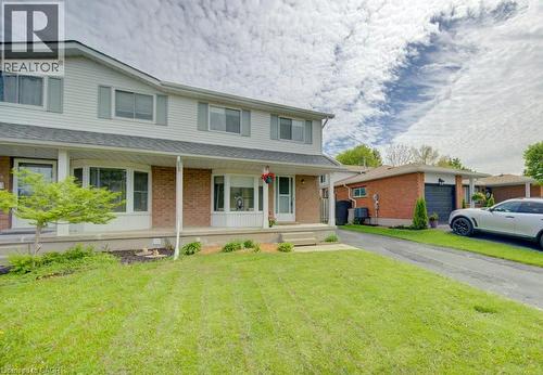 Two-story residence featuring light siding and brick accents - 603 Pinerow Crescent Unit# B, Waterloo, ON 