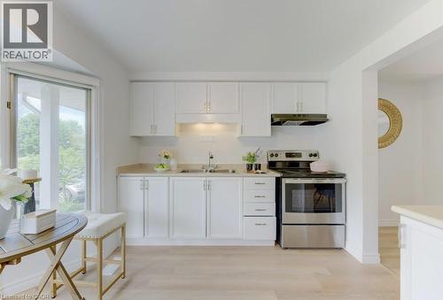 Kitchen featuring white cabinetry, light-toned countertops, and stainless steel appliances - 603 Pinerow Crescent Unit# B, Waterloo, ON 