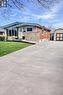 Bungalow exterior featuring brick and stone veneer, siding accents, and a covered porch - 241 Thorner Drive, Hamilton, ON  - Outdoor 