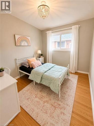 Room featuring wood-finish flooring and a beaded chandelier - 241 Thorner Drive, Hamilton, ON - Indoor Photo Showing Bedroom