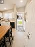 Kitchen and entryway featuring light tile flooring, white cabinetry, recessed lighting, and a vaulted ceiling - 241 Thorner Drive, Hamilton, ON  - Indoor 