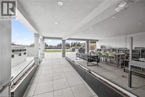 Expansive covered patio featuring light-toned large format tile flooring & recessed lightingty - 153 Wilson Street W Unit# 310, Ancaster, ON -  Photo Showing Other Room