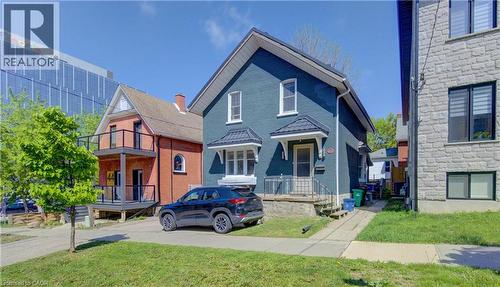 Two-story residence with steel roof, white trim windows, and a covered entry - 48 Breithaupt Street, Kitchener, ON - Outdoor With Facade