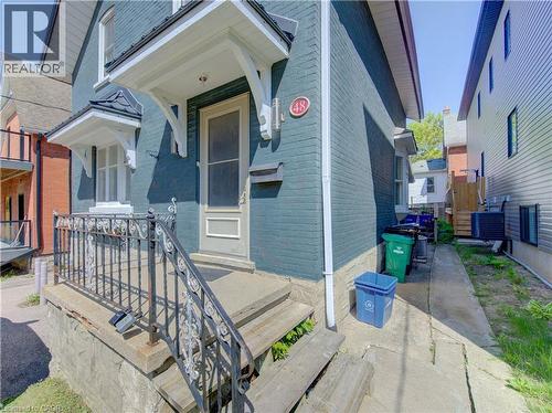Front entrance to upper and main level units featuring a decorative iron railing, and a covered entry - 48 Breithaupt Street, Kitchener, ON - Outdoor