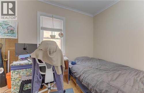 Room featuring light-toned walls, crown molding, and wood-finish flooring - 48 Breithaupt Street, Kitchener, ON - Indoor Photo Showing Bedroom
