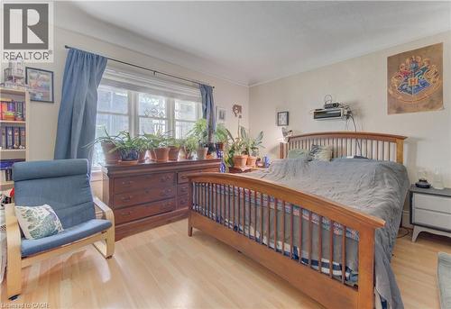 Light wood-finish flooring complements the neutral wall color - 48 Breithaupt Street, Kitchener, ON - Indoor Photo Showing Bedroom