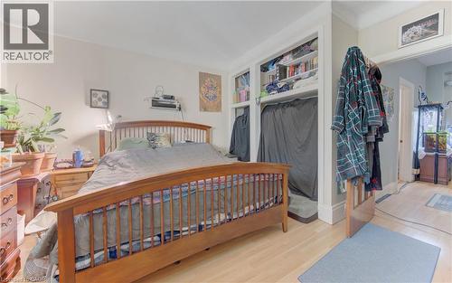 Room featuring light wood-finish flooring, built-in shelving, and neutral wall tones - 48 Breithaupt Street, Kitchener, ON - Indoor Photo Showing Bedroom