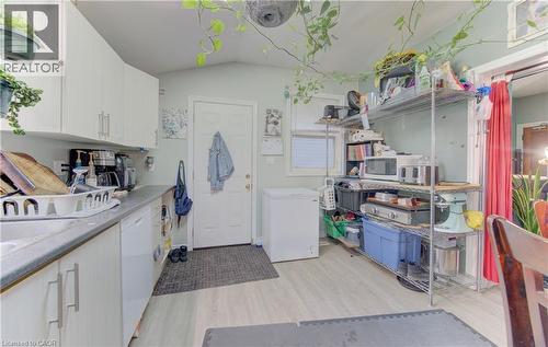 kitchen featuring white faced cabinetry, a light-coloured countertop, and wood-finish flooring - 48 Breithaupt Street, Kitchener, ON - Indoor