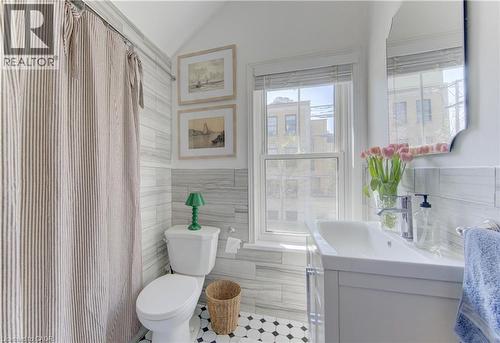 Bathroom featuring a white toilet, contemporary single-sink vanity, and hexagonal floor tiling - 48 Breithaupt Street, Kitchener, ON - Indoor Photo Showing Bathroom