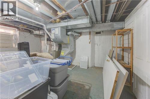 Basement utility space featuring exposed ceiling joists, white painted walls, and a visible HVAC system - 48 Breithaupt Street, Kitchener, ON - Indoor Photo Showing Basement