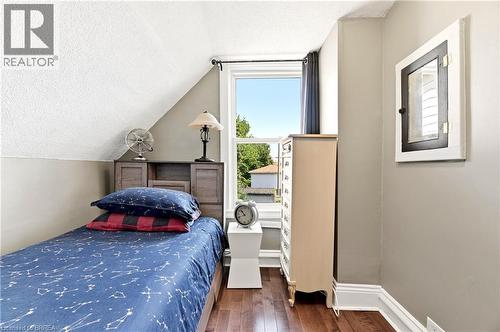 Hardwood-finish flooring complementing neutral wall tones - 23 Britannia Avenue, Hamilton, ON - Indoor Photo Showing Bedroom