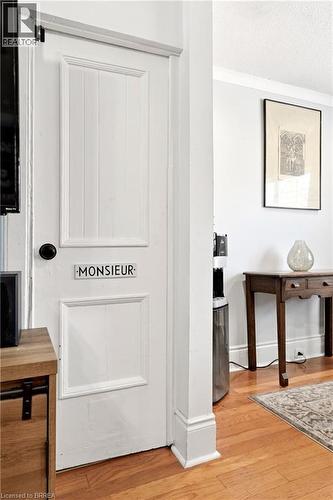 Crisp white paneled door featuring a black knob and decorative trim - 23 Britannia Avenue, Hamilton, ON - Indoor Photo Showing Other Room