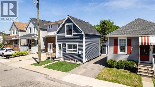 Two-story residence featuring horizontal siding and a prominent dormer - 23 Britannia Avenue, Hamilton, ON - Outdoor With Facade