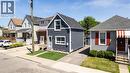 Two-story residence featuring horizontal siding and a prominent dormer - 23 Britannia Avenue, Hamilton, ON  - Outdoor With Facade 