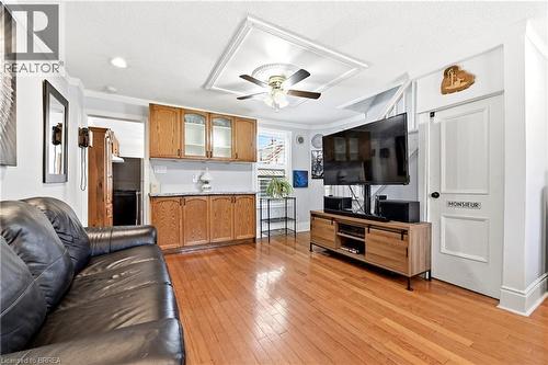 Open concept living area featuring wood-finish flooring, recessed lighting, and a ceiling fan with a decorative medallion - 23 Britannia Avenue, Hamilton, ON - Indoor