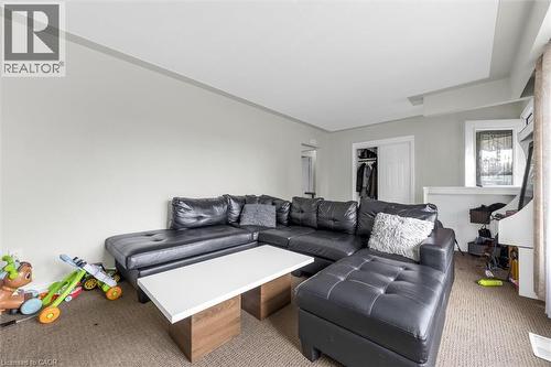 Carpeted living area featuring light neutral wall tones and white trim - 46 Beaconsfield Drive, Hamilton, ON - Indoor Photo Showing Living Room