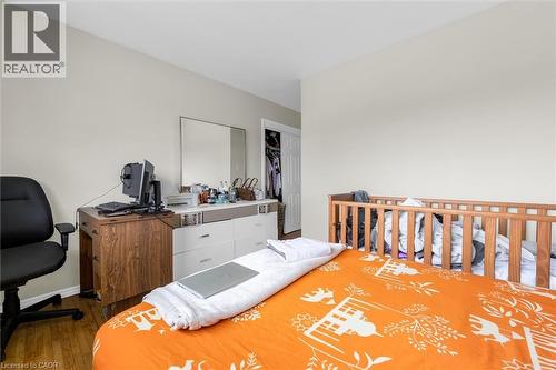 Bedroom featuring light-toned walls, wood-finish flooring, and a closet with a bifold door - 46 Beaconsfield Drive, Hamilton, ON - Indoor
