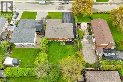 Expansive property featuring a large green lawn, mature trees, and an extended paved driveway - 46 Beaconsfield Drive, Hamilton, ON - Outdoor With View