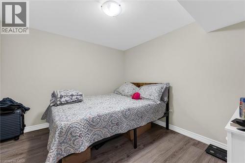 Bedroom featuring wood-finish flooring, light-toned walls, white baseboards, and a flush-mount ceiling light - 46 Beaconsfield Drive, Hamilton, ON - Indoor Photo Showing Bedroom