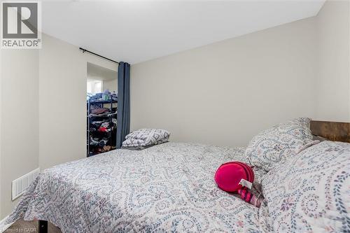 Bedroom featuring light-toned wall paint and wood-finish flooring - 46 Beaconsfield Drive, Hamilton, ON - Indoor Photo Showing Bedroom