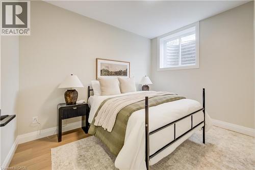 Light-filled room featuring a single window, light wood-finish flooring, and white baseboards - 210 Heritage Drive Unit# Main, Kitchener, ON - Indoor Photo Showing Bedroom