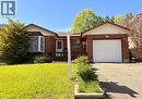 Traditional brick exterior featuring a white garage door and a bay window - 146 Bechtel Drive, Kitchener, ON  - Outdoor 