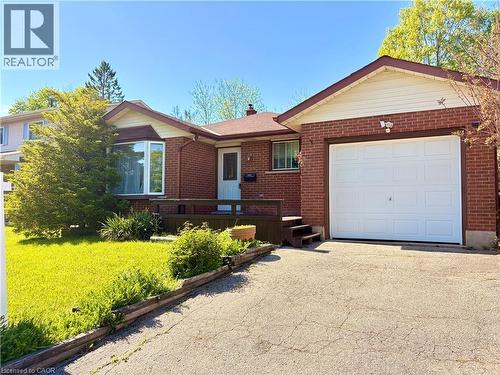 Brick exterior featuring a single-car garage and a paved driveway - 146 Bechtel Drive, Kitchener, ON - Outdoor With Exterior