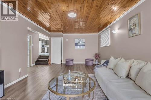 Living area featuring wood finished floors, wooden ceiling, and crown molding - 146 Bechtel Drive, Kitchener, ON - Indoor Photo Showing Living Room