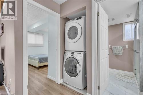 Laundry area with healthy amount of natural light and stacked washer and dryer - 146 Bechtel Drive, Kitchener, ON - Indoor Photo Showing Laundry Room
