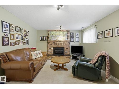 210 Porter Av, Millet, AB - Indoor Photo Showing Living Room With Fireplace