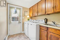 Laundry room with side entrance, access to garage - 