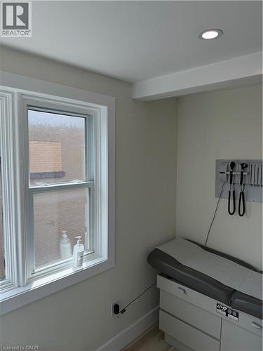 Recessed ceiling lighting illuminates a room with light neutral wall tones and wide window trim - 357 Main Street E Unit# Main Floor, Hamilton, ON 