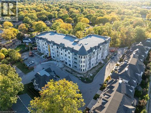 Modern multi-story building featuring a distinctive curved facade and multiple balconies - 2 Arbourvale Common Unit# 209, St. Catharines, ON - Outdoor With View