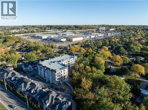 Modern multi-story building featuring balconies and a distinctive turret architectural element - 2 Arbourvale Common Unit# 209, St. Catharines, ON - Outdoor With View