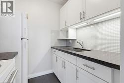Updated kitchen stone counters, backsplash, microwave shelve, under cabinet lighting - 
