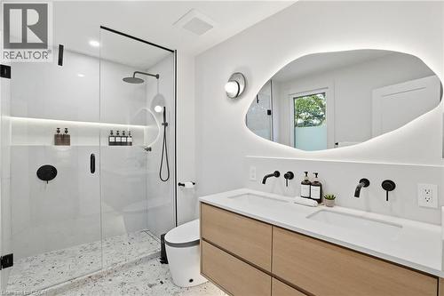 Modern bathroom featuring a dual vanity with a light wood-finish cabinet and white countertop - 345 Rankin Drive, Burlington, ON - Indoor Photo Showing Bathroom