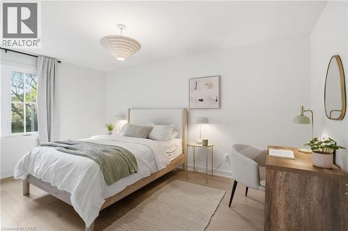 Bedroom featuring light wood-finish flooring, a white window frame, and a contemporary ceiling light fixture - 345 Rankin Drive, Burlington, ON - Indoor Photo Showing Bedroom