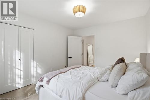 White-painted room featuring a gold-toned flush-mount light fixture - 345 Rankin Drive, Burlington, ON - Indoor Photo Showing Bedroom