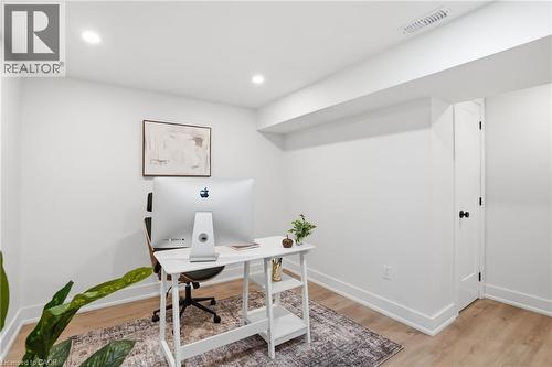 White-painted interior space featuring recessed ceiling lighting, a partial drop ceiling, wood-finish flooring, and white baseboards - 345 Rankin Drive, Burlington, ON - Indoor Photo Showing Office