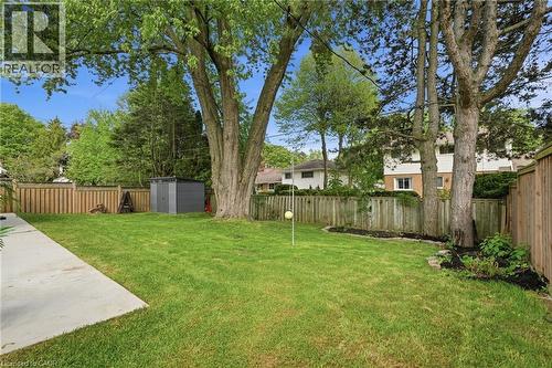 Expansive lawn with mature trees and a concrete patio - 345 Rankin Drive, Burlington, ON - Outdoor