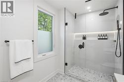 Modern shower enclosure featuring clear glass panels and matte black hardware - 
